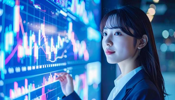 ディルプレイのチャートの前に立つ女性社員の写真