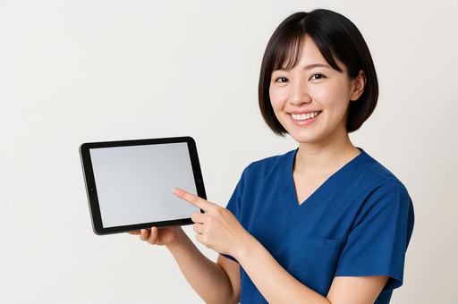 タブレットを指差す看護師 タブレットを指差す看護師の写真