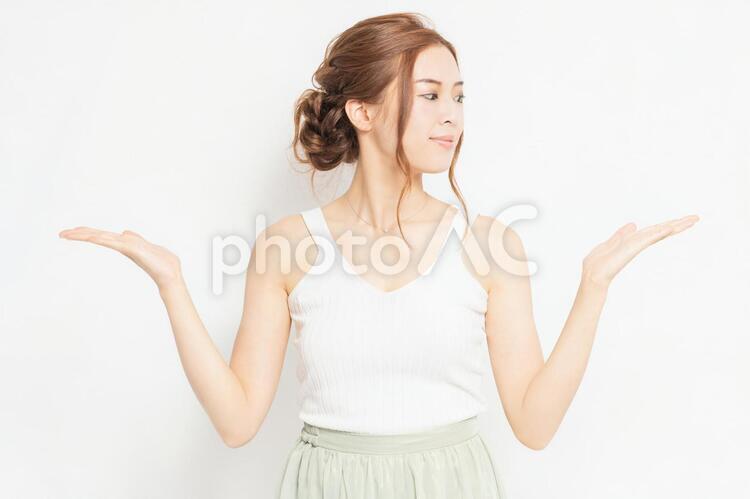 案内のジェスチャーをする若い女性 女性,案内,説明の写真素材