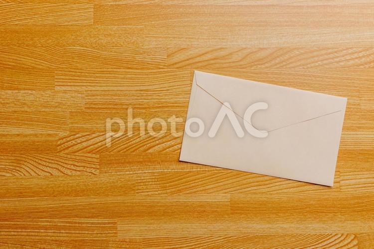 机に置かれたベージュの封筒 封筒,手紙,レターの写真素材
