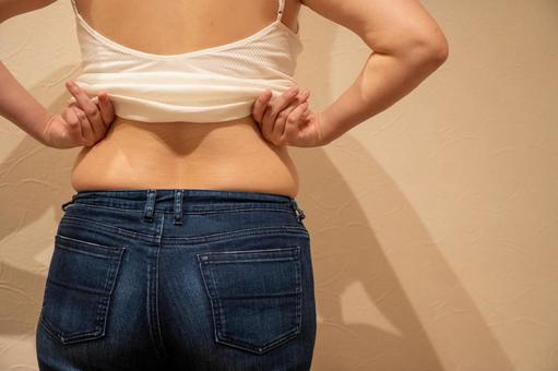 デニムパンツにのった腰回りのぜい肉2 ダイエット,セルライト,脂肪燃焼の写真素材