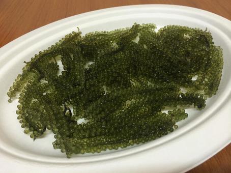 Fresh, firm Okinawan sea grapes served on a paper plate, JPG