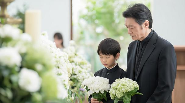 教会でのお葬式と白い花を持つ父と子 教会でのお葬式と白い花を持つ父と子の写真