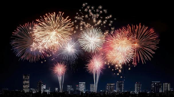 高層ビル群と都会の花火、夏の夜空の写真