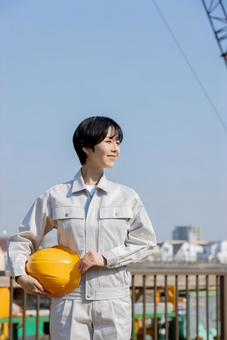 Woman in work clothes at a construction site, JPG