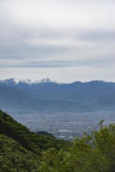 山から望む春の甲府盆地と南アルプス 甲府盆地,笛吹市,中央市の写真素材