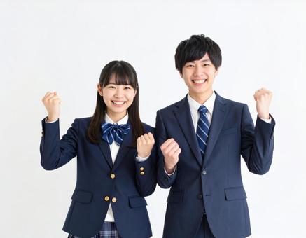 ガッツポーズでエールを送る男女高校生 ガッツポーズでエールを送る男女高校生の写真
