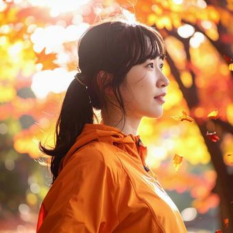 紅葉の中　スポーツウェアを着た女性の写真