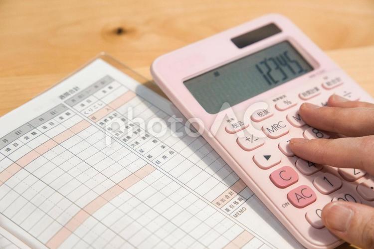 家計簿で収我が家の収支を管理する主婦 貯金,家計簿,お金の写真素材