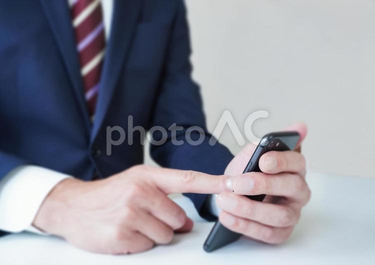 スマートフォンを操作するビジネスマン ビジネスマン,スマホ,操作の写真素材