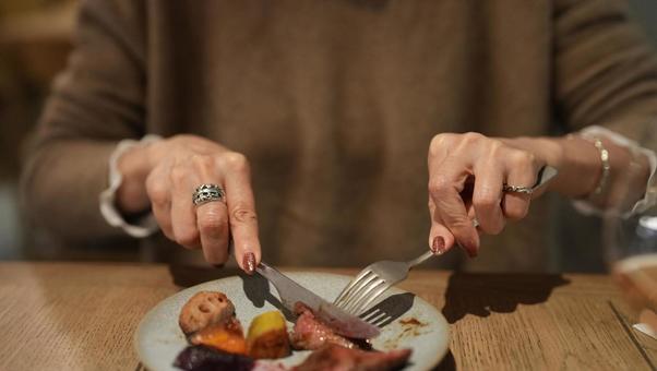 食事をする女性 女性,食事,ナイフの写真素材