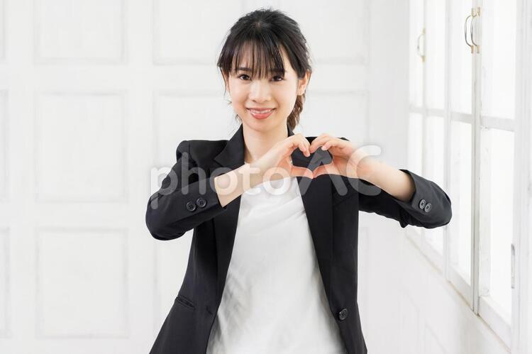 手でハートを作る若いビジネスウーマン 女性,ハート,気持ちの写真素材