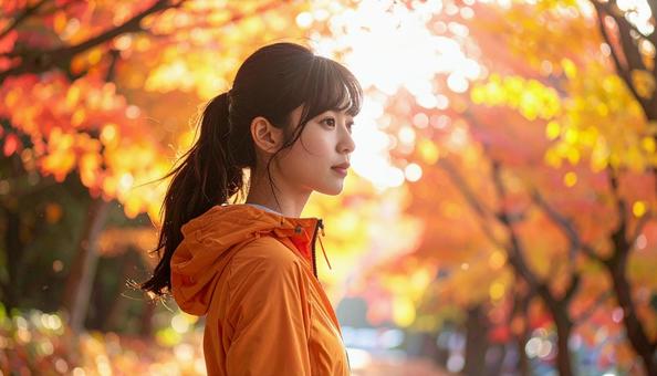 紅葉の中 スポーツウェアを着た女性 紅葉の中 スポーツウェアを着た女性の写真