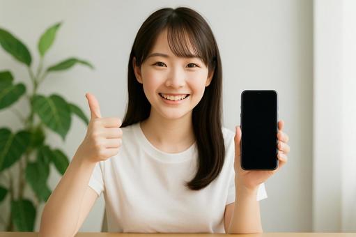 スマホとグッドサイン スマホとグッドサインの写真