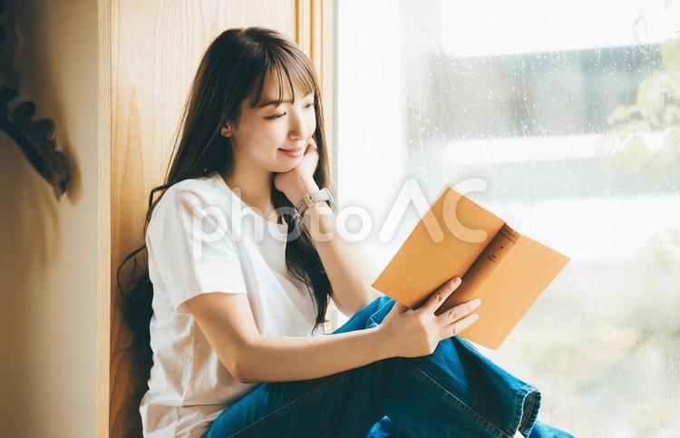 窓際で読書をする女性 女性,読書,本の写真素材