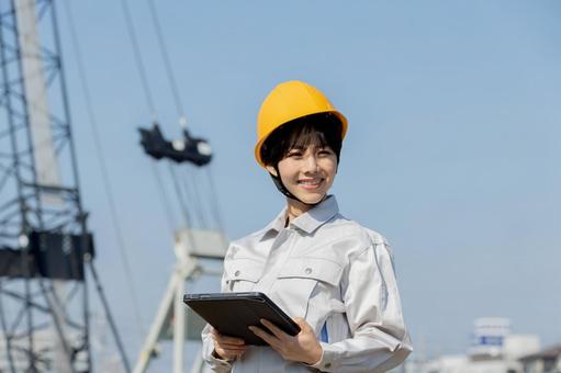Woman in work clothes at a construction site, JPG