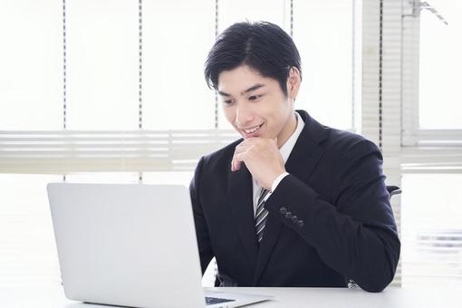 A businessman operating a laptop, male, businessman, laptop, JPG