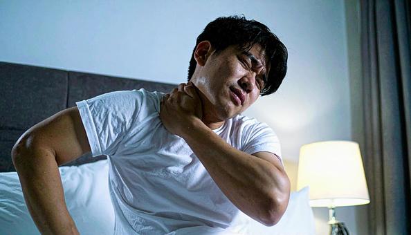 寝違えて首痛に苦しむ男性 寝違えて首痛に苦しむ男性の写真