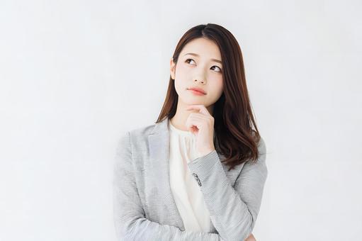 ビジネスシーンの考え込む女性。白背景 ビジネスシーンの考え込む女性。白背景の写真