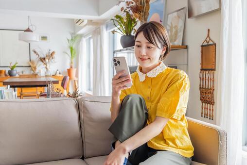 携帯を操作している女性 女性,スマホ,スマートフォンの写真素材