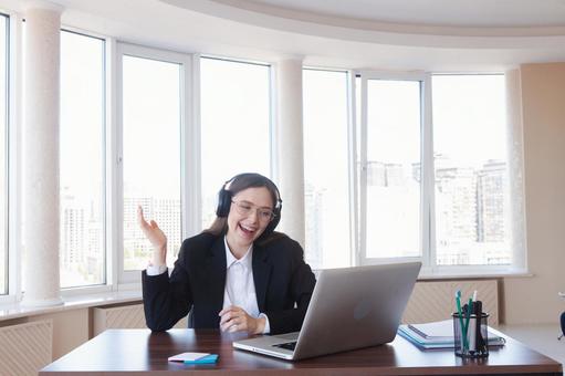 パソコンを見ながら笑顔で話す女性 女性,外国人,ノートパソコンの写真素材