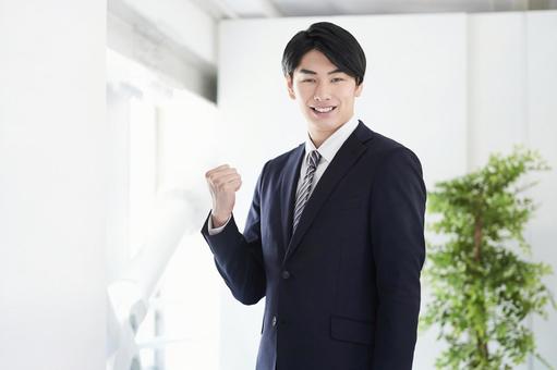 Japanese male businessman doing guts pose looking at the camera, człowiek, biznesmen, uśmiech, JPG