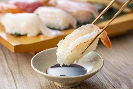 Pick up delicious looking sushi on a plate with chopsticks, JPG