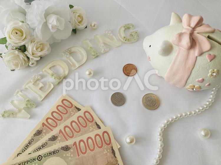 WEDDINGの文字とお金と貯金箱と薔薇 wedding,結婚式,結婚の写真素材