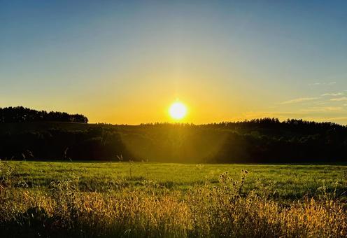 Sunset over the mountains and illuminated grassland, JPG Sunset over the mountains and illuminated grassland, JPG