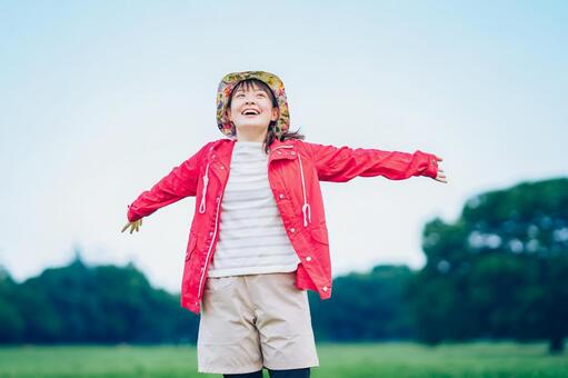 草原でリラックスした表情の女性  女性,笑顔,充実の写真素材
