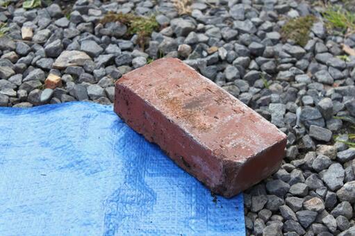 Brick weight, it is old., outdoors, there are not many people, JPG