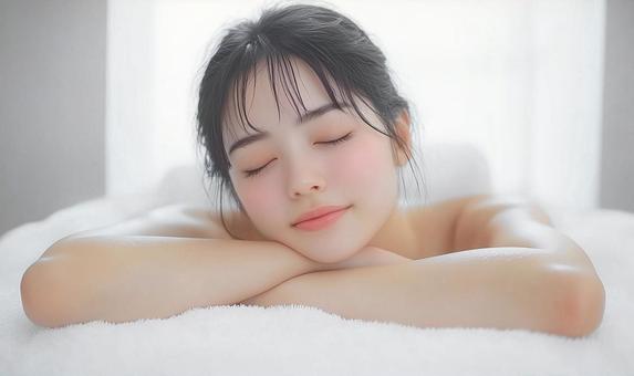 美容エステでリラックスして眠る若い女性 美容エステでリラックスして眠る若い女性の写真