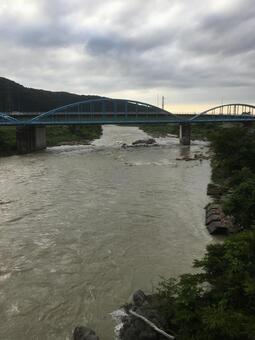 茶色い濁流が激しく流れる梅雨の手取川 茶色い濁流が激しく流れる梅雨の手取川の写真