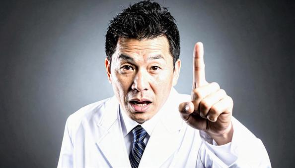 注意! 人差し指を立てる白衣を着た男性 注意! 人差し指を立てる白衣を着た男性の写真