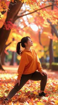 スポーツの秋 紅葉の中でストレッチ 女性 スポーツの秋 紅葉の中でストレッチ 女性の写真