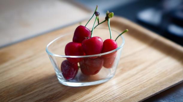 The freshness of cherries shines through the transparent glass, JPG