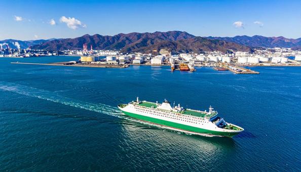 港を航行するフェリーと対岸の工場地帯 港を航行するフェリーと対岸の工場地帯の写真