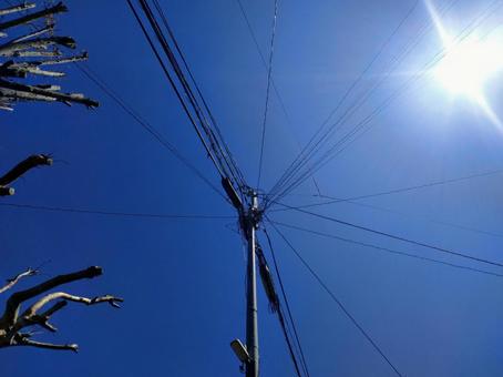 Blue sky, sun, electric poles and wires, JPG Blue sky, sun, electric poles and wires, JPG