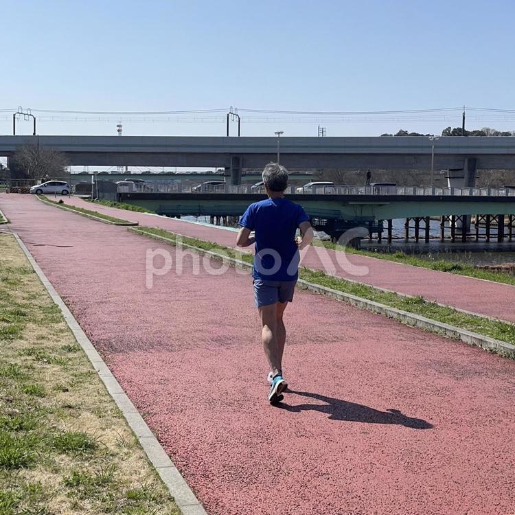 川沿いをジョギングする男性 男性,男,走るの写真素材