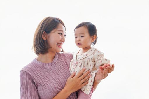 赤ちゃんを抱っこするお母さん 子育て,白背景,元気の写真素材