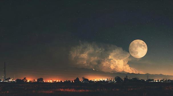 雲間から輝く巨大な満月が照らす夜景 雲間から輝く巨大な満月が照らす夜景の写真