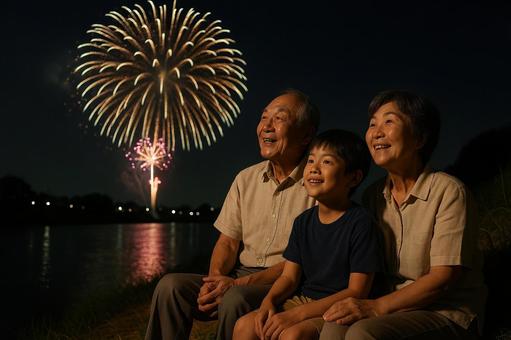 花火を見上げる祖父母と孫 花火を見上げる祖父母と孫の写真