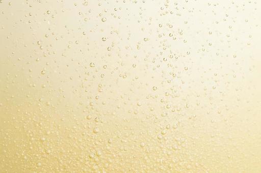 シャンパンカラーの液体と気泡のテクスチャの写真