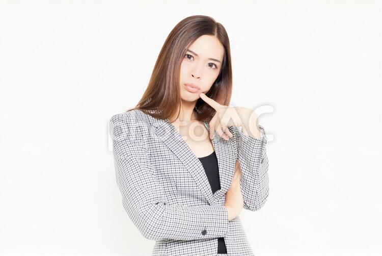 考えるジェスチャーをするビジネスウーマン 女性,考える,悩むの写真素材