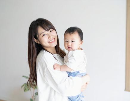 赤ちゃんを抱っこするお母さん 赤ちゃんを抱っこするお母さんの写真