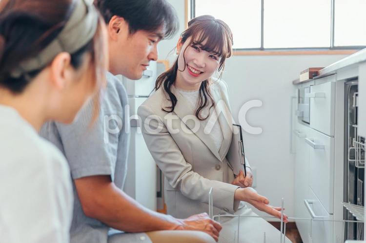 キッチンの設備を説明する女性（食洗機） モデルルーム,食洗機,食器洗い乾燥機の写真素材