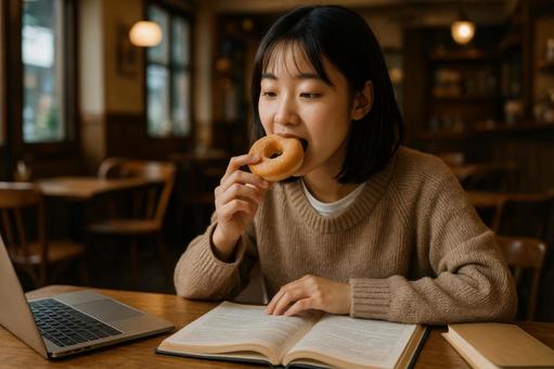 学生が勉強しながら食べるドーナツの写真