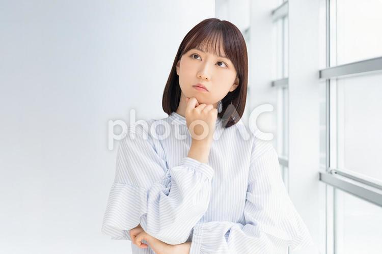 考えごとをする若い女性・ビジネスウーマン 女性,考える,悩むの写真素材