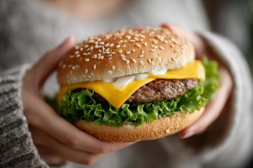 とろけるチーズが食欲をそそるハンバーガー とろけるチーズが食欲をそそるハンバーガーの写真