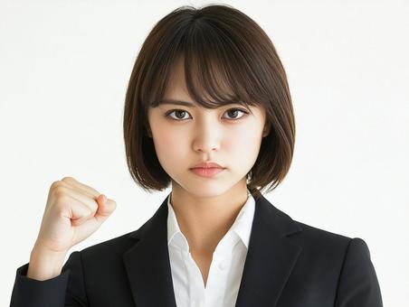 こぶしを固めるビジネスウーマンのイメージ こぶしを固めるビジネスウーマンのイメージの写真